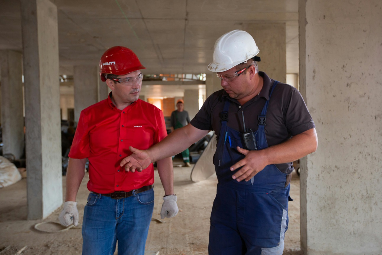 two construction workers discussing project