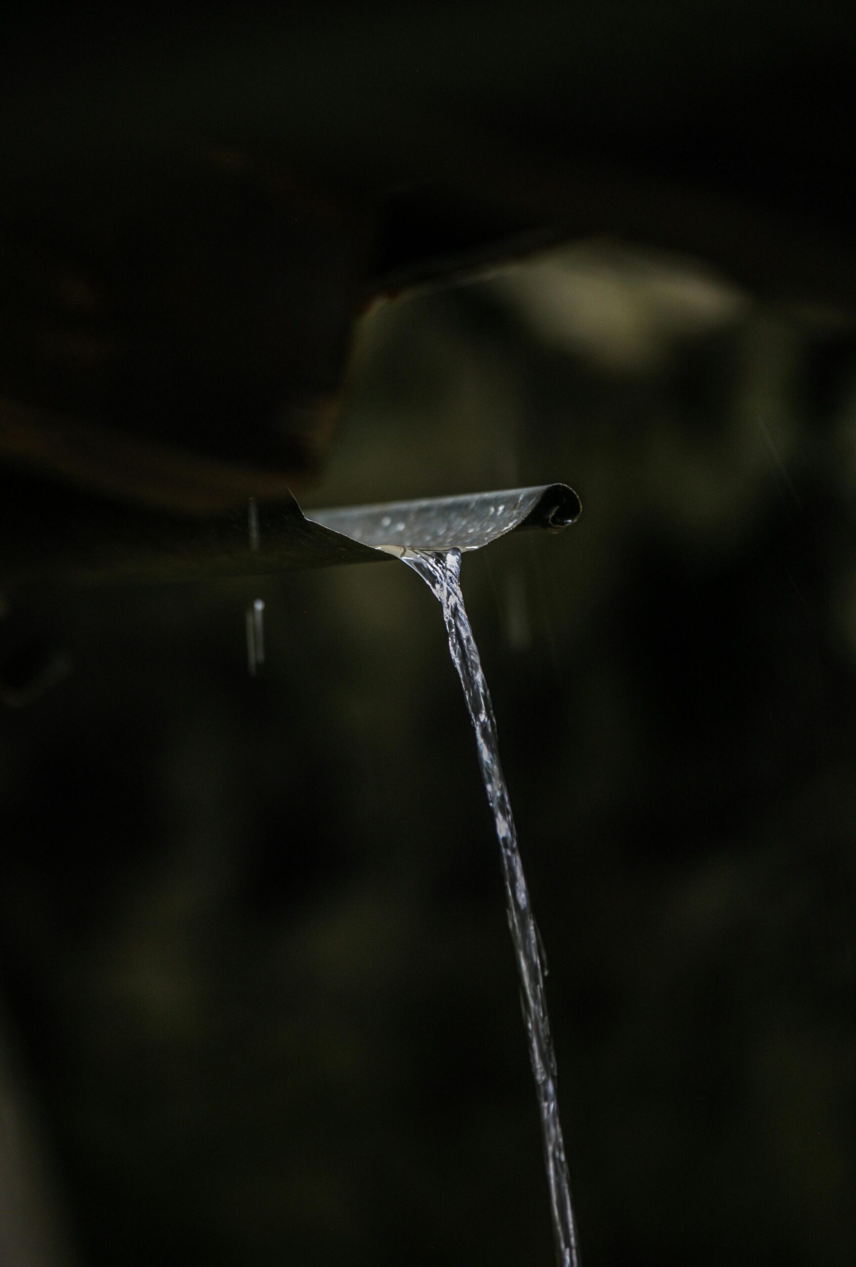 Close-up of Water Dripping Down gutter