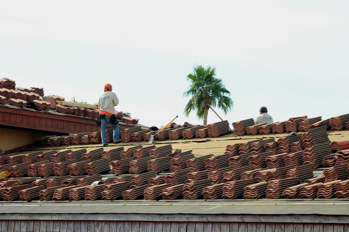 roofers working on tile roof