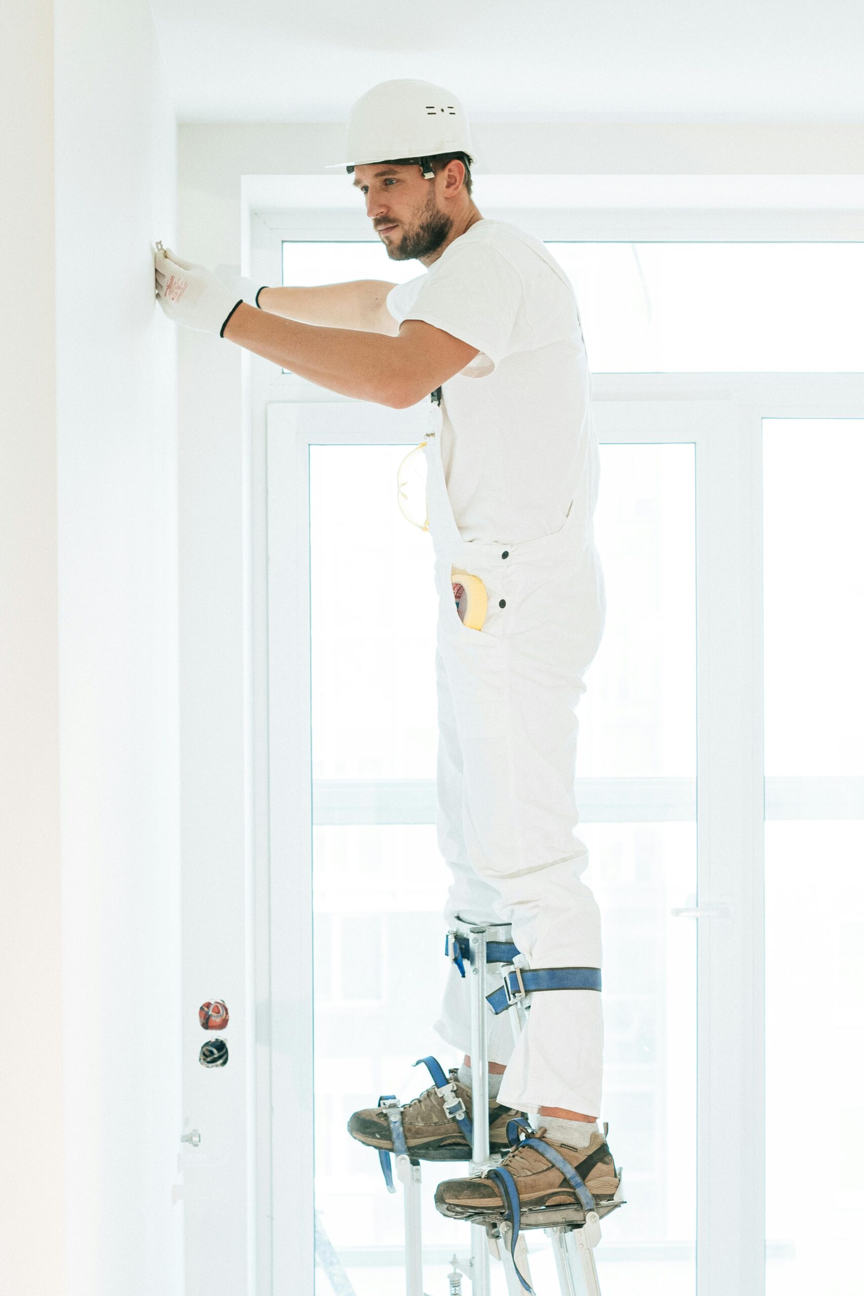 A professional painter applying paint with precision to a wall