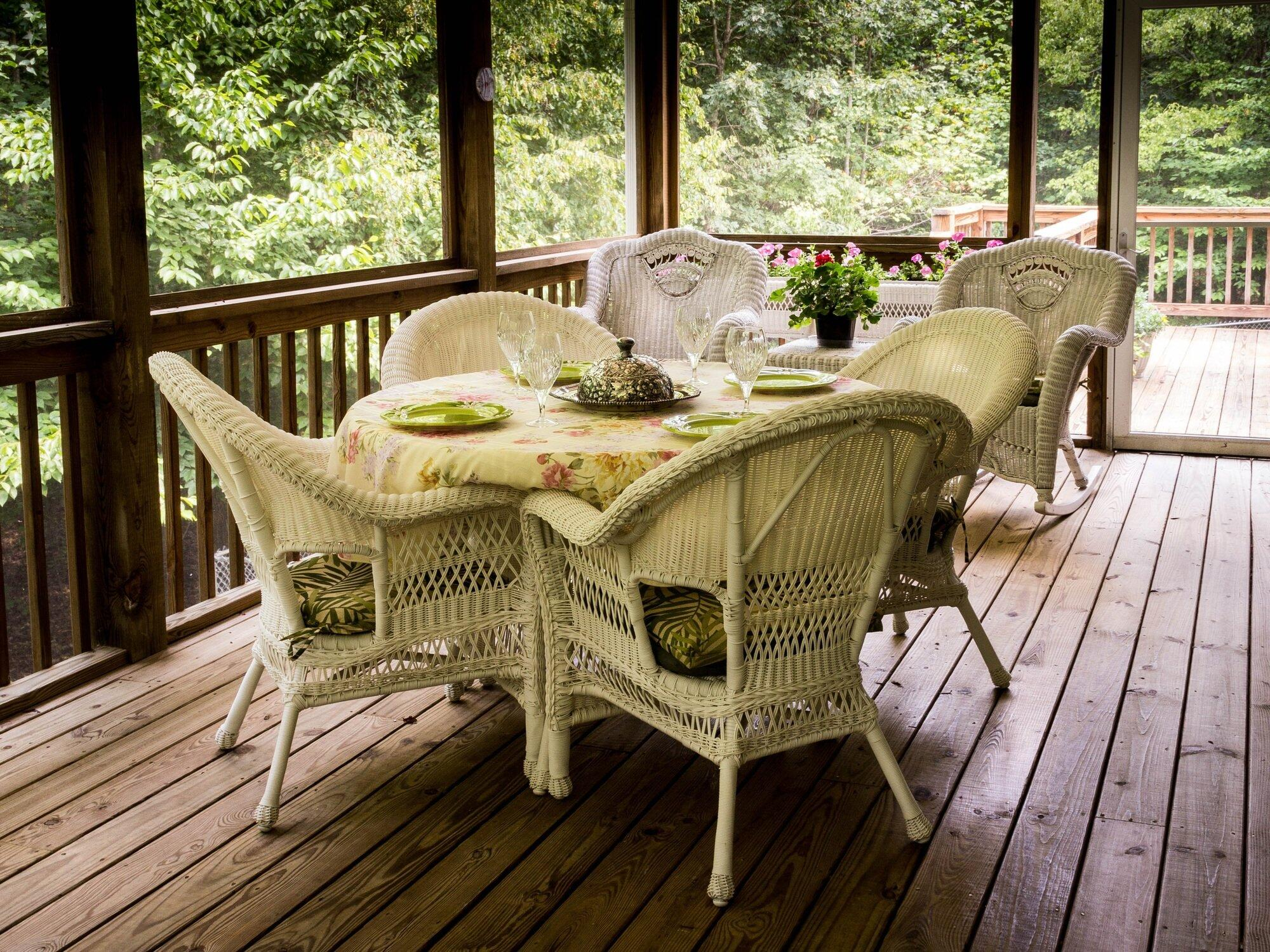 screened porch with table and chairs