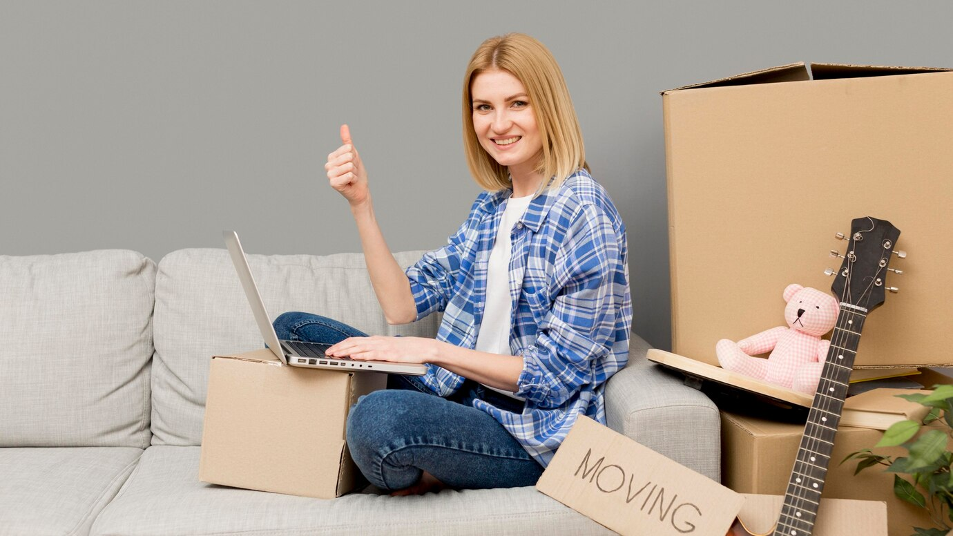 woman on a laptop preparing for moving